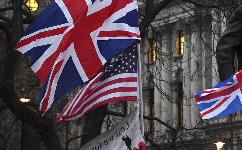 FILE - In this file photo dated Friday, Jan. 31, 2020, Brexit supporters hold British and US flags during a rally in London. The international reputation of the United States has declined further in the wake of its handling of the coronavirus pandemic, according to new research published Tuesday Sept. 15, 2020, from the Pew Research Center. (AP Photo/Alberto Pezzali, FILE)