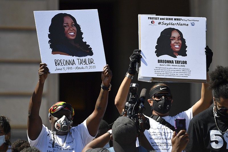 FILE - Signs are held up showing Breonna Taylor during a rally in her honor on the steps of the Kentucky State Capitol in Frankfort, Ky., Thursday, June 25, 2020. The city of Louisville will pay several million dollars to the mother of Breonna Taylor and install police reforms as part of a settlement of a lawsuit from Taylor’s family, The Associated Press has learned. (AP Photo/Timothy D. Easley, File)
