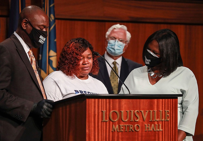 Tamika Palmer, mother of Breonna Taylor, center, speaks during a news conference Tuesday, Sept. 15, 2020 in Louisville, Ky. Beside Palmer is attorney Ben Crump at left and attorney Lonita Baker at right. Palmer briefly spoke at Metro Hall Tuesday afternoon during a press conference to announce a $12 million settlement to Breonna Taylor's estate. Taylor was shot by Louisville police in March during a botched execution of a search warrant.  (Matt Stone/Courier Journal via AP)