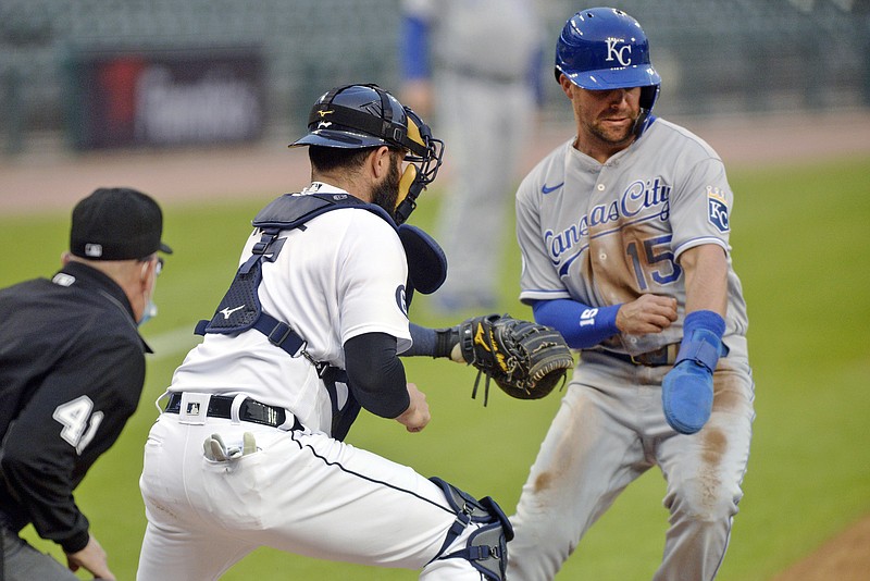 Tigers catcher Austin Romine tags out Whit Merrifield of the Royals during the first inning of Tuesday night's game in Detroit.