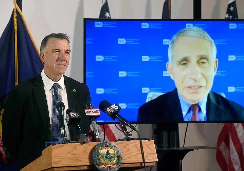 Vermont's Gov. Phil Scott, left, listens as Dr. Anthony Fauci, director of the National Institute of Allergy and Infectious Diseases, discusses Vermont's response to the COVID-19 pandemic during a press conference Tuesday, Sept. 15, 2020, in Montpelier, Vt. (Jeb Wallace-Brodeur/The Times Argus via AP)