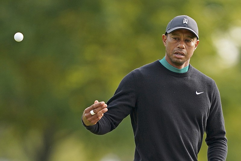 Tiger Woods tosses a ball onto the 11th green during practice Tuesday for the U.S. Open Championship at Winged Foot Golf Club in Mamaroneck, N.Y.