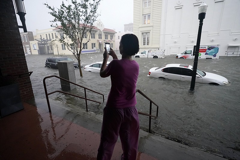 Flood waters move on the street, Wednesday, Sept. 16, 2020, in downtown Pensacola, Fla. Hurricane Sally made landfall Wednesday near Gulf Shores, Alabama, as a Category 2 storm, pushing a surge of ocean water onto the coast and dumping torrential rain that forecasters said would cause dangerous flooding from the Florida Panhandle to Mississippi and well inland in the days ahead.(AP Photo/Gerald Herbert)