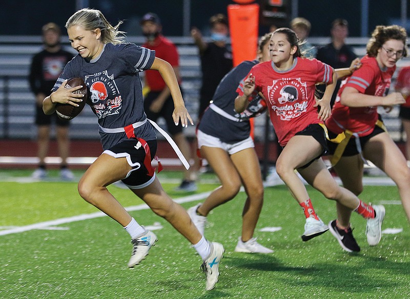 Jefferson City senior Hannah Nilges runs the ball up the field Wednesday while playing quarterback during the annual JCHS Powder Puff flag football game at Adkins Stadium. Nilges was also part of the homecoming court; she plans to play basketball at Drake University next year.