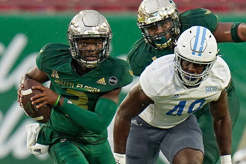 South Florida quarterback Jordan McCloud (3) breaks away from Citadel linebacker Marquise Blount (49) during the first half of an NCAA college football game Saturday, Sept. 12, 2020, in Tampa, Fla. (AP Photo/Chris O'Meara)