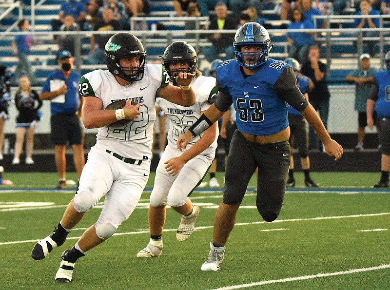 North Callaway running back Trevor Ray tries to distance himself from South Callaway linebacker Kyle Dickinson during a Week 2 game in Mokane.