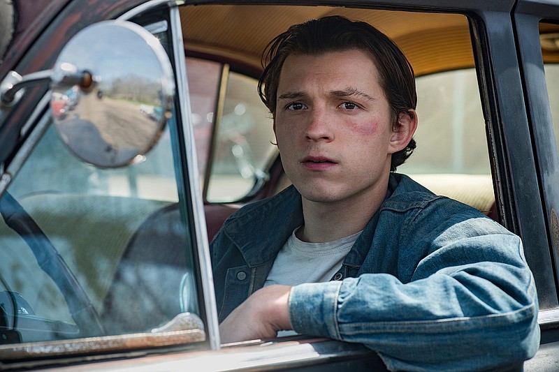 This image released by Netflix shows Tom Holland in a scene from "The Devil All The Time." Antonio Campos' Appalachian noir film premieres Wednesday on Netflix. (Glen Wilson/Netflix via AP)