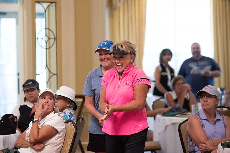  Lillian Granger and Debbie Magee walk to receive their prizes for winning the 52nd annual Twice as Nice championship at the Texarkana Country Club on Thursday in Texarkana.