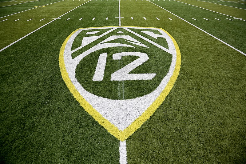 In this Oct. 10, 2015, file photo, a PAC-12 logo is displayed on the field before an NCAA college football game between Washington State and Oregon in Eugene, Ore. The Pac-12 university presidents and chancellors will meet Friday, Sept. 17, 2020, and be presented options for staging a fall football season, but Commissioner Larry Scott says a vote by the the CEO Group is not expected. (AP Photo/Ryan Kang, File)