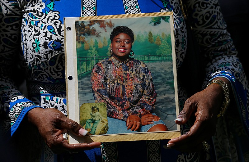In this May 16, 2019 file photo, Antoinette Dorsey-James holds a picture of her sister Pamela Turner during a news conference outside the Harris County Civil Court in Houston. Baytown Police Officer Juan Delacruz has been charged with assault for fatally shooting Turner in the parking lot of an apartment complex where they both lived in May 2019 prosecutors announced Monday, Sept. 14, 2020. (Godofredo A Vasquez/Houston Chronicle via AP File)
