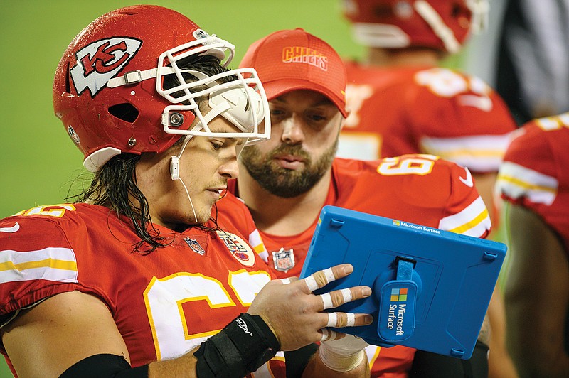 Chiefs center Austin Reiter talks with teammate Daniel Kilgore during last Thursday night's win against the Texans at Arrowhead Stadium.