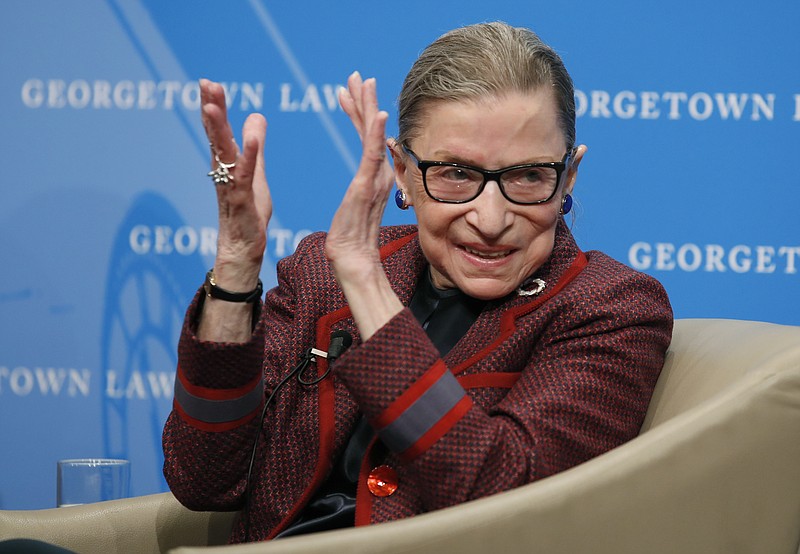FILE - In this April 6, 2018, file photo, Supreme Court Justice Ruth Bader Ginsburg applauds after a performance in her honor after she spoke about her life and work during a discussion at Georgetown Law School in Washington. The Supreme Court says Ginsburg has died of metastatic pancreatic cancer at age 87. (AP Photo/Alex Brandon, File)