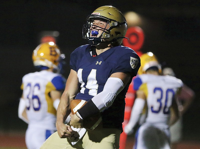 Helias quarterback Jacob Weaver yells in celebration after running for a touchdown during Friday's game at Ray Hentges Stadium.