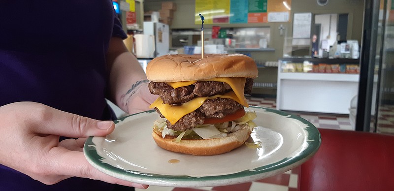 Old Tyme Burger Shoppe of Texarkana, Arkansas, displays an example of their double patty cheeseburger. They consider the simplicity of their cheeseburgers the key, with toasted buns, fresh meat and a configuration that offers a complete meal in itself.