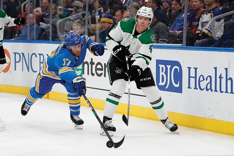 In this Feb. 8 file photo, Miro Heiskanen passes around Blues center Jaden Schwartz during the second period of a game in St. Louis.