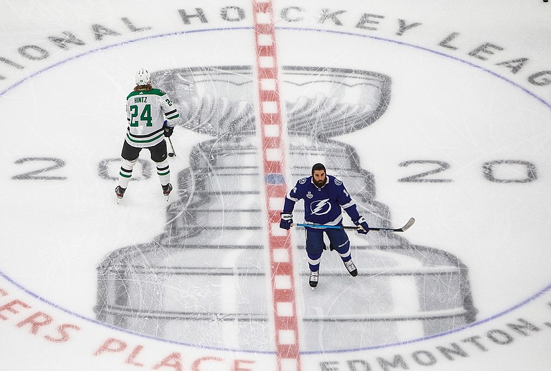 Dallas Stars' Roope Hintz (24) and Tampa Bay Lightning left wing Patrick Maroon (14) warm up before NHL Stanley Cup finals hockey action in Edmonton, Alberta, Saturday, Sept. 19, 2020. (Jason Franson/The Canadian Press via AP)