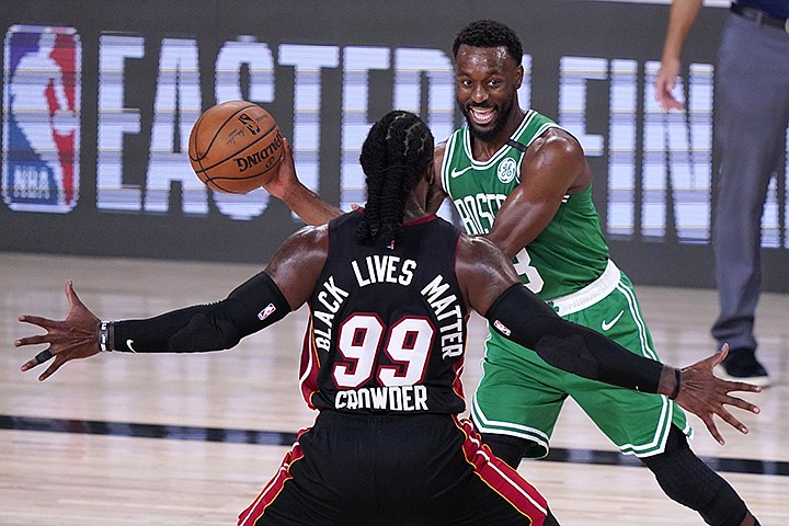 Miami Heat forward Jae Crowder (99) defends as Boston Celtics guard Kemba Walker (8) attempts to make a pass during the second half of an NBA conference final playoff basketball game, Saturday, Sept. 19, 2020, in Lake Buena Vista, Fla. (AP Photo/Mark J. Terrill)