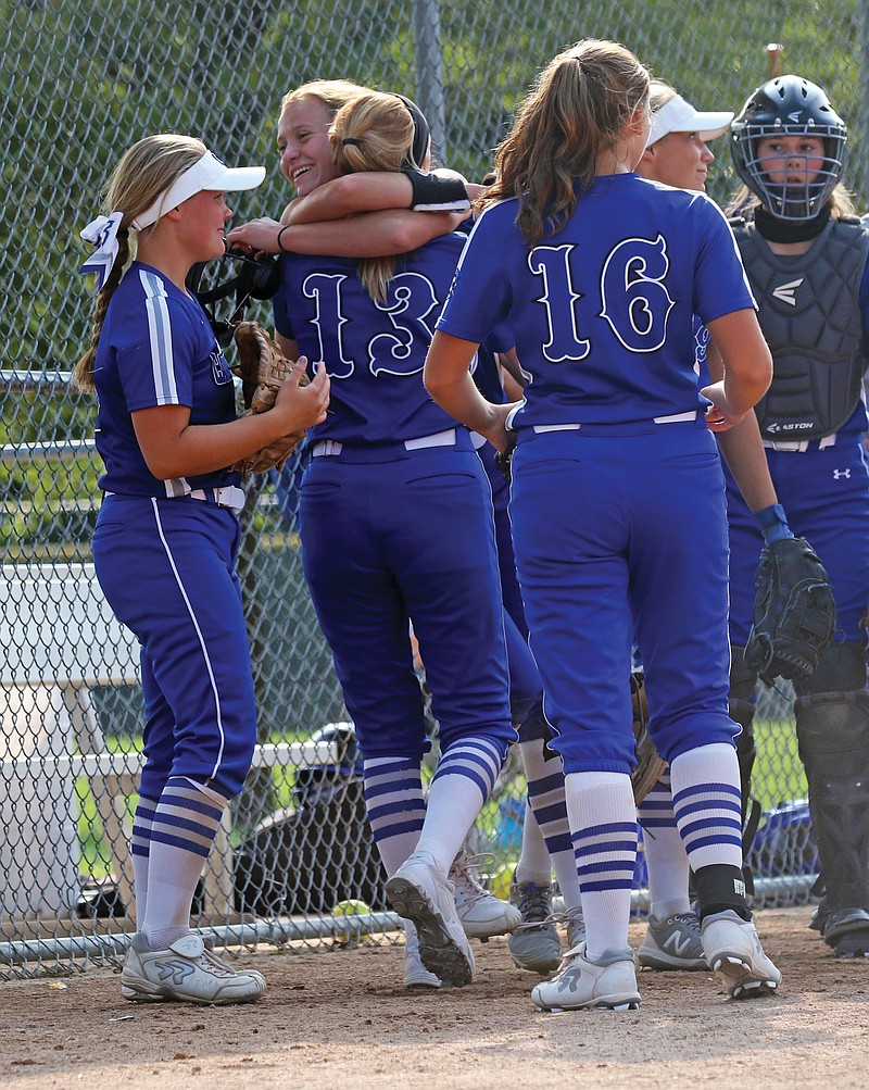 Capital City's Lydia Coulson (13) hugs teammate Olivia Wood after the Lady Cavaliers defeated Helias on Saturday afternoon in the fifth-place game of the Lady Jays Classic at Binder Park.