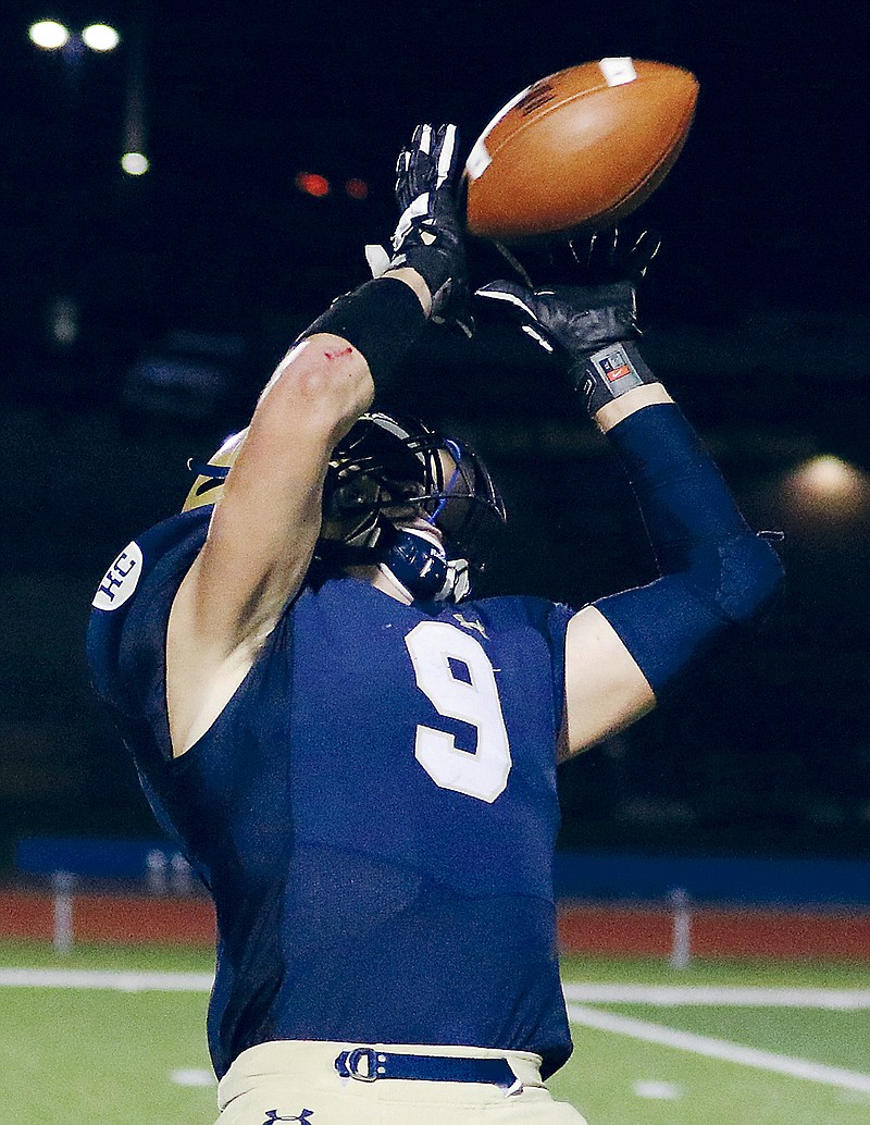 Helias receiver Damon Johanns reaches back to make a catch during the fourth quarter of Friday night's game against Borgia at Ray Hentges Stadium. Johanns ran the ball into the end zone for a touchdown.