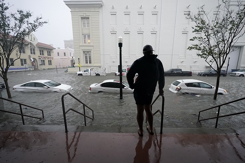 FILE - Floodwaters move on the street, Wednesday, Sept. 16, 2020, in Pensacola, Fla.  The Census Bureau is contending with several natural disasters as wildfires and hurricanes disrupt the final weeks of the nation’s once-a-decade headcount. (AP Photo/Gerald Herbert)