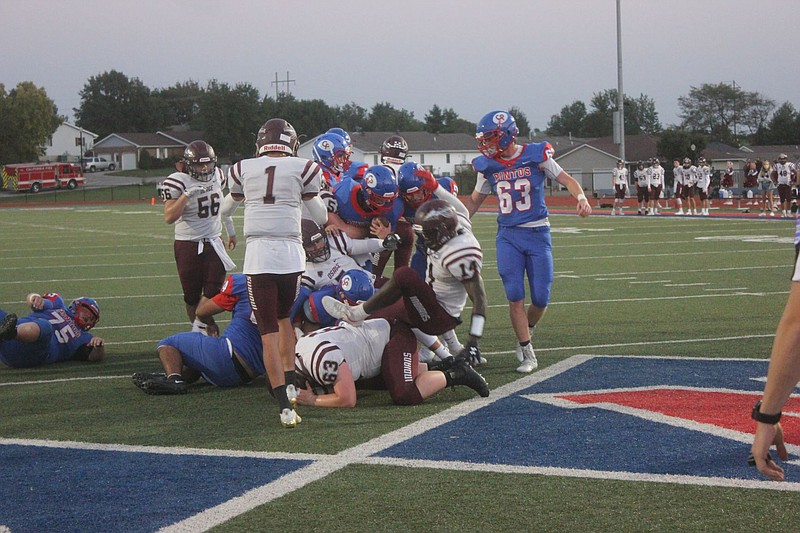 <p>Democrat photo/Kevin Labotka</p><p>Calen Kruger fights through Osage’s defense to get to the end zone Sept. 18 during the Pintos’ win over Osage. Kruger played a strong game for the Pintos, contributing a pair of rushing scores and throwing three touchdown passes.</p>