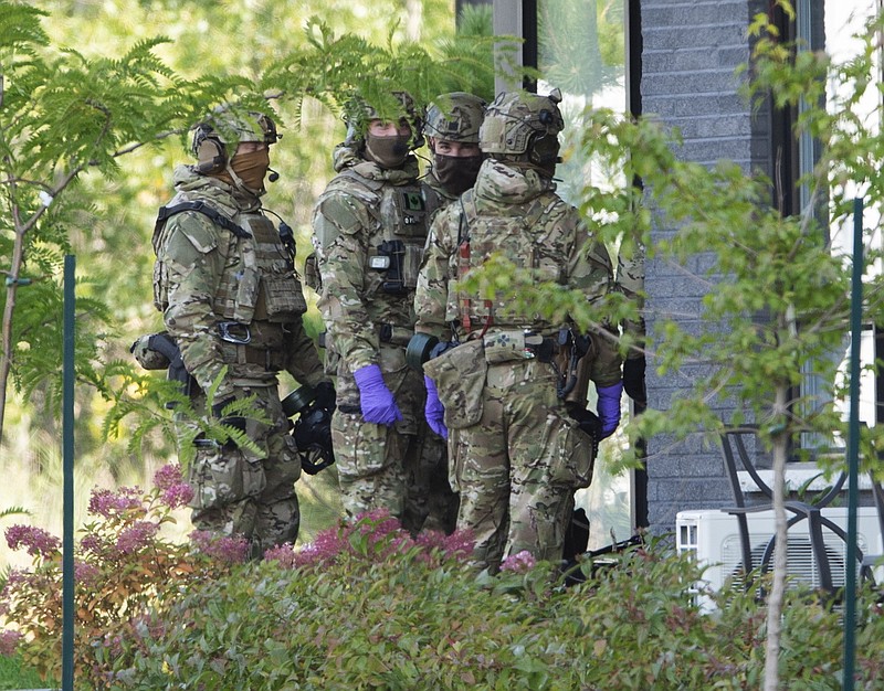 RCMP officers prepare to enter an apartment complex in connection with the mailing of ricin to President Trump Monday, Sept. 21, 2020 in St. Hubert, Canada. (Ryan Remiorz/The Canadian Press via AP)