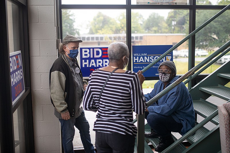 Attendees engage in conversation Tuesday after the Miller County Democratic Party Headquarters grand opening. The headquarters is in the Bethel Building at 403 E. Ninth St.