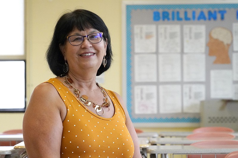 Geraldine Swann, director of community outreach at Hampstead Hill Academy in Baltimore, poses for a photograph Monday, Aug. 31, 2020, in Baltimore. The pandemic has Geri Swann working her cell phone constantly, as she gets up to 100 emails a day seeking help for students and their families. Finding them Chromebooks, buying eyeglasses for kids squinting at screens. Helping people get unemployment checks. Delivering groceries so a woman can feed her school-aged grandchildren while their parents recover from COVID-19.  This is what a community schools coordinator does _ and as a new academic year begins in the throes of coronavirus infections, Swann has only been busier in support of the struggling families at her diverse Baltimore charter school.(AP Photo/Julio Cortez)