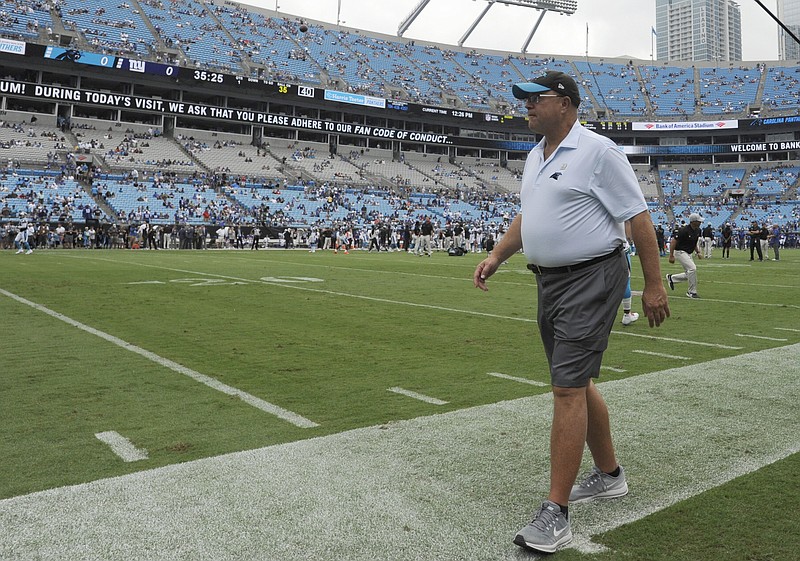 FILE - In this Oct. 7, 2018, file photo, Carolina Panthers owner David Tepper walks the field before the NFL football team's game against the New York Giants in Charlotte, N.C. Tepper expressed frustration with government officials over not allowing fans in the stadium for the team’s Sept. 13 home opener against the Las Vegas Raiders. Tepper said he’ll continue to have conversations with government officials, including North Carolina Gov. Roy Cooper, about allowing the team to bring in a limited number of fans into Bank of America Stadium for future home games this season. (AP Photo/Mike McCarn, File)