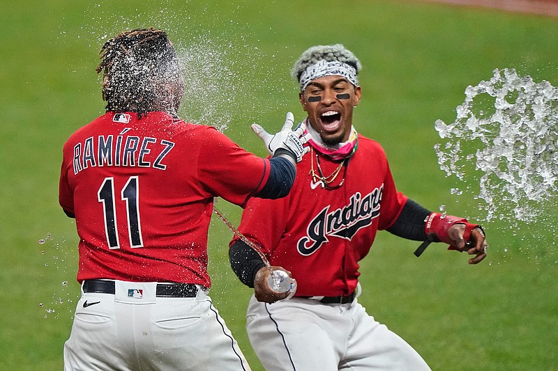 Cleveland Indians' Francisco Lindor, right, tosses water on Jose Ramirez after Ramirez hit a three-run home run in the tenth inning of a baseball game against the Chicago White Sox, Tuesday, Sept. 22, 2020, in Cleveland. The Indians won in ten innings. (AP Photo/Tony Dejak)