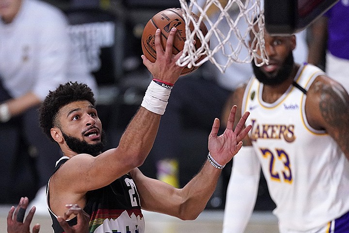 Denver Nuggets guard Jamal Murray, left, goes up for a shot attempt as Los Angeles Lakers' LeBron James, right rear, looks on during the second half of Game 3 of the NBA basketball Western Conference final Tuesday, Sept. 22, 2020, in Lake Buena Vista, Fla. (AP Photo/Mark J. Terrill)