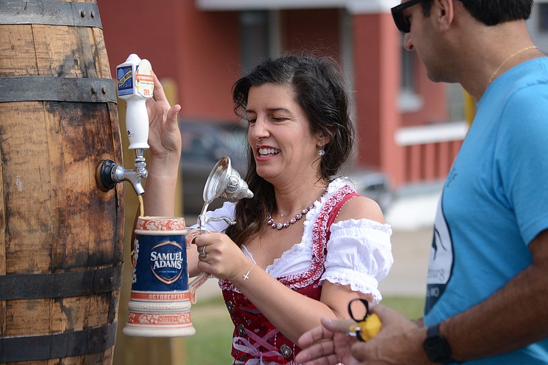 <p style="text-align:right;">News Tribune file</p><p><strong>Mayor Carrie Tergin fills a beer stein Sept. 28 during the 2019 Oktoberfest tapping of the keg ceremony. This year’s event is set for 10 a.m.-4 p.m. Saturday. </strong></p>
