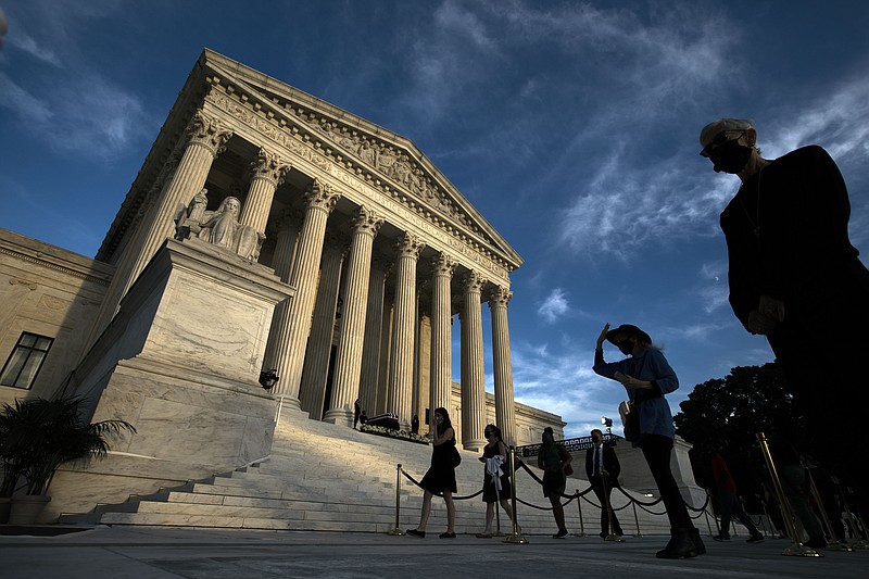 Mourners pay their respects as Justice Ruth Bader Ginsburg lies in repose under the Portico at the top of the front steps of the U.S. Supreme Court building on Wednesday, Sept. 23, 2020, in Washington. Ginsburg, 87, died of cancer on Sept. 18. (AP Photo/Jose Luis Magana)