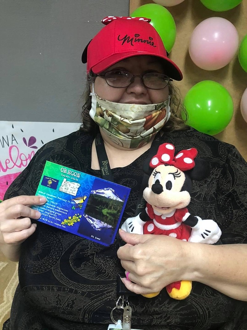 Kimberly, a resident at The Retreat at Kenwood, poses with her gifts and a postcard from her pen pal in Oregon. (Submitted photo)
