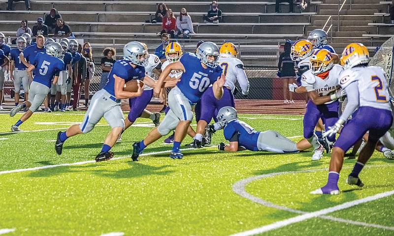 Capital City lineman Adam Alonzo leads the way for running back Ethan Wood during a game earlier this season against Hickman at Adkins Stadium.  