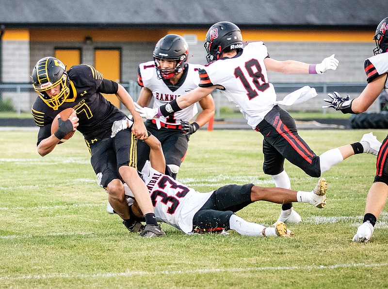 Fulton receiver Seth Sayler leans forward for extra yardage after making a catch during last Friday night's game against Hannibal at Robert E. Fisher Stadium.