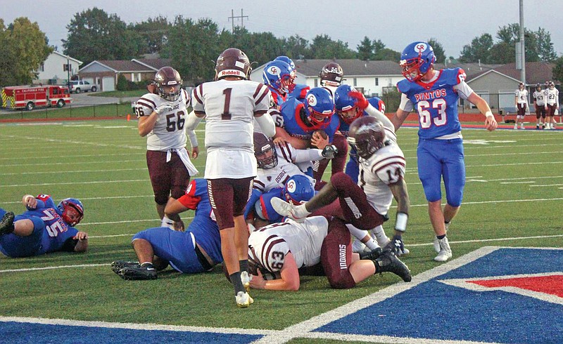 California's Calen Kruger fights through School of the Osage's defense to cross the goal line during last Friday night's game in California.