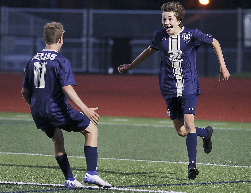 Helias midfielder Jonah Lanigan runs to leap into teammate Carter Prenger's arms after scoring the first goal of Wednesday's game against Rock Bridge at Ray Hentges Stadium. It was also Lanigan's first varsity goal.