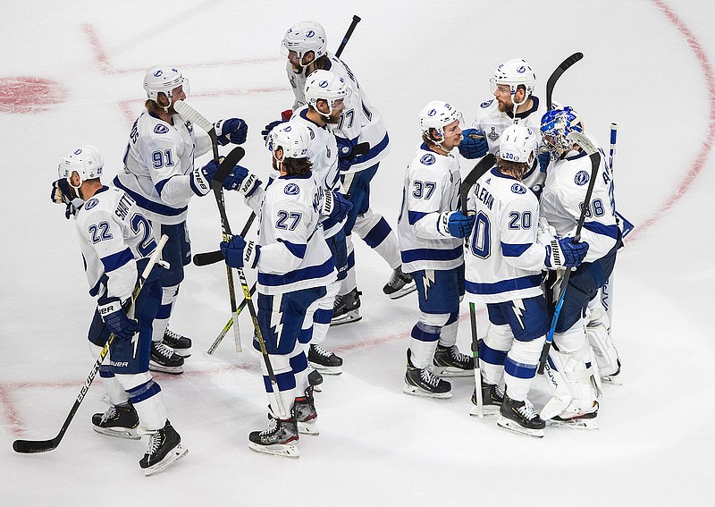 Tampa Bay Lightning players celebrate a win over the Dallas Stars in Game 3 of the NHL hockey Stanley Cup Final, Wednesday, Sept. 23, 2020, in Edmonton, Alberta. (Jason Franson/The Canadian Press via AP)