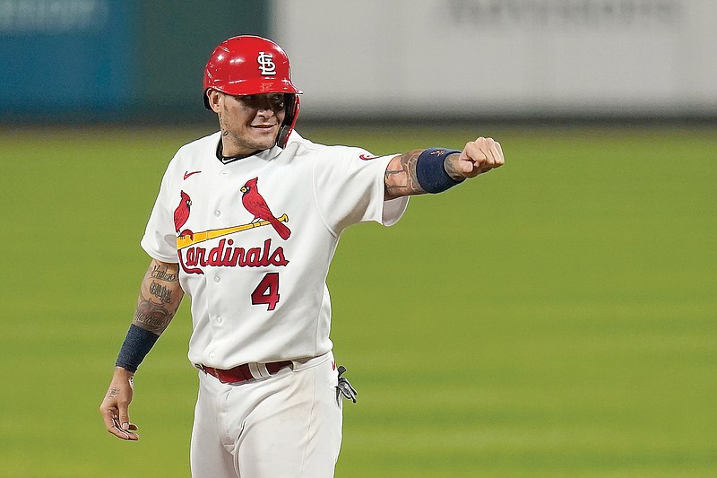 Yadier Molina gestures toward the Cardinal dugout after hitting a single for his 2,000th career hit during the seventh inning of Thursday night's game against the Brewers at Busch Stadium.