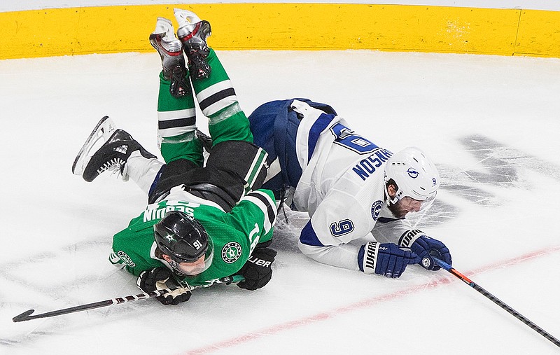 Dallas Stars center Tyler Seguin (91) and Tampa Bay Lightning center Tyler Johnson (9) become entangled during the first period of Game 4 of the NHL hockey Stanley Cup Final, Friday, Sept. 25, 2020, in Edmonton, Alberta. (Jason Franson/The Canadian Press via AP)