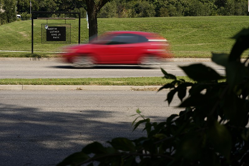 A car passes Martin Luther King Jr. park adjacent to Swope Parkway Thursday, Sept. 24, 2020, in Kansas City, Mo. The stretch of road, along with parts of two other streets, would be renamed to honor King under a city proposal coming in the wake of failed effort to honor King last year. (AP Photo/Charlie Riedel)