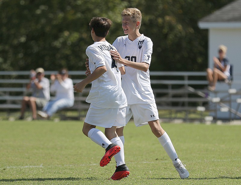 Nick Ammons congratulates Helias teammate Jaxon Meller (4) on scoring a goal Saturday against North County during the Richard Wilson Classic at the 179 Soccer Park.