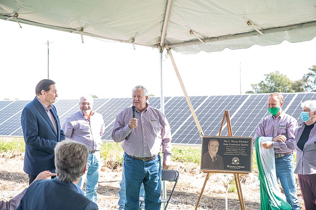  Rusty Pendergraft, board president, announces the dedication of a solar facility to C. Wayne Whitaker, who has been Southwest Arkansas Electric Cooperative's manager for 35 years.