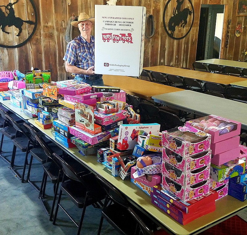 Moniteau County Toys for Tots Program Coordinator Dan Mesey stands next to a table filled with 165 toys donated by employees at California's Dollar General store Monday, Sept. 28, 2020.