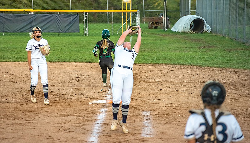 Helias first baseman Cori Verslues catches a foul ball off the bat of Rock Bridge's Cydney Fullerton during Monday's game at the American Legion Post 5 Sports Complex.