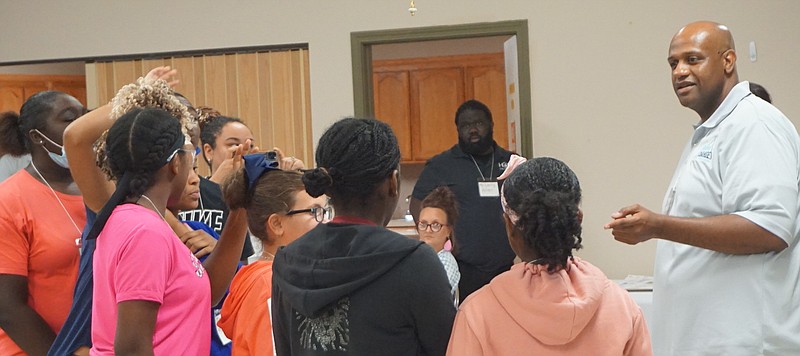 Dr. Robert Harper, right, is being surrounded by eager students attending the first phase of a community engagement program for youth and law enforcement held in Linden in August. In the background is Larry Love, head of the Linden Together support group.