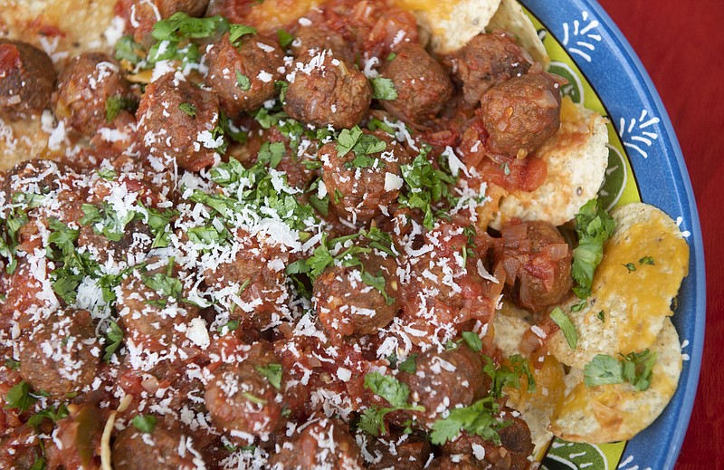 Nachos with meatballs features two crowd-pleasers packed as one hearty snack. Pork meatballs are dunked into a chunky salsa and served on cheesy tortilla chips. (Emily Matthews/Post-Gazette/TNS)