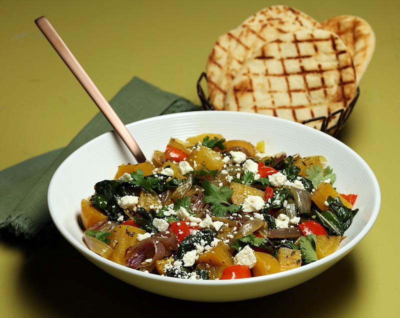 Grilled golden beets center a fall salad that makes a colorful dinner, with sauteed beet greens, red onions, bell pepper, herbs and crumbled feta. (Terrence Antonio James/Chicago Tribune/TNS) 