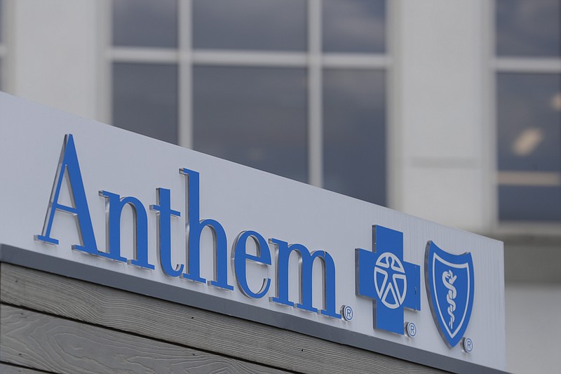 FILE - In this May 14, 2019, file photo signage on the outside of the corporate headquarters building of health insurance company Anthem is shown in Indianapolis. Anthem has agreed to another multi-million dollar-settlement over a cyberattack on its technology that exposed the personal information of nearly 79 million people. The Blue Cross-Blue Shield insurer said Wednesday, Sept. 30, 2020 that it will pay $39.5 million to settle an investigation by a group of state attorneys general.   (AP Photo/Michael Conroy, File)